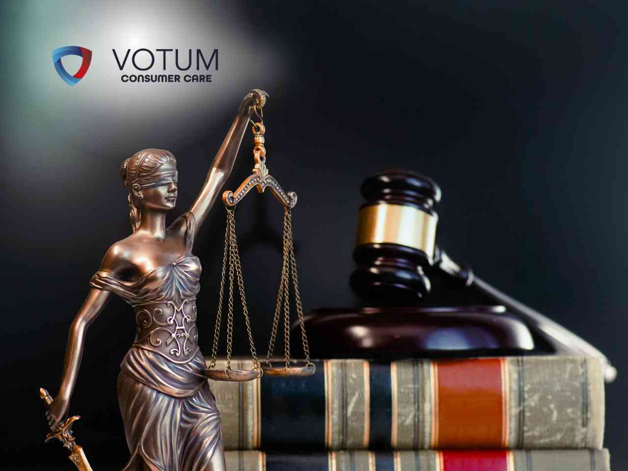 Statue of Lady Justice holding scales and a gavel with law books; VOTUM Consumer Care logo in the top left.