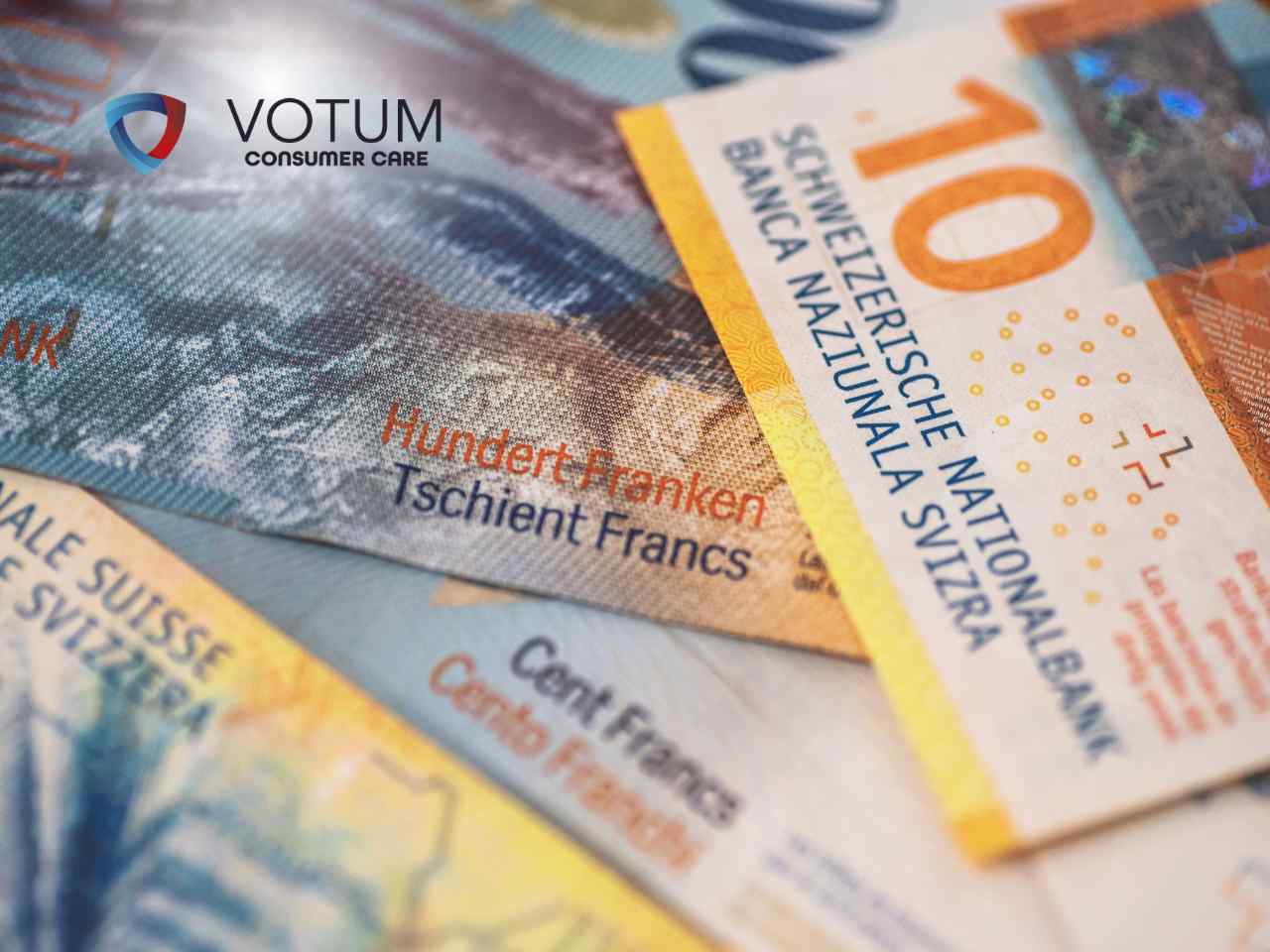 jak-frankowicz-moze-odzyskac-prowizje Close-up of Swiss banknotes with the VOTUM Consumer Care logo in the top left corner.